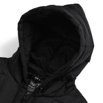 Close-up of a black hooded jacket with a brand label on a white background