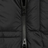 Close-up of a black puffer jacket with a zipper