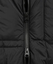 Close-up of a black puffer jacket with a zipper