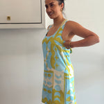 Woman holding a colorful towel with a geometric pattern against a white background
