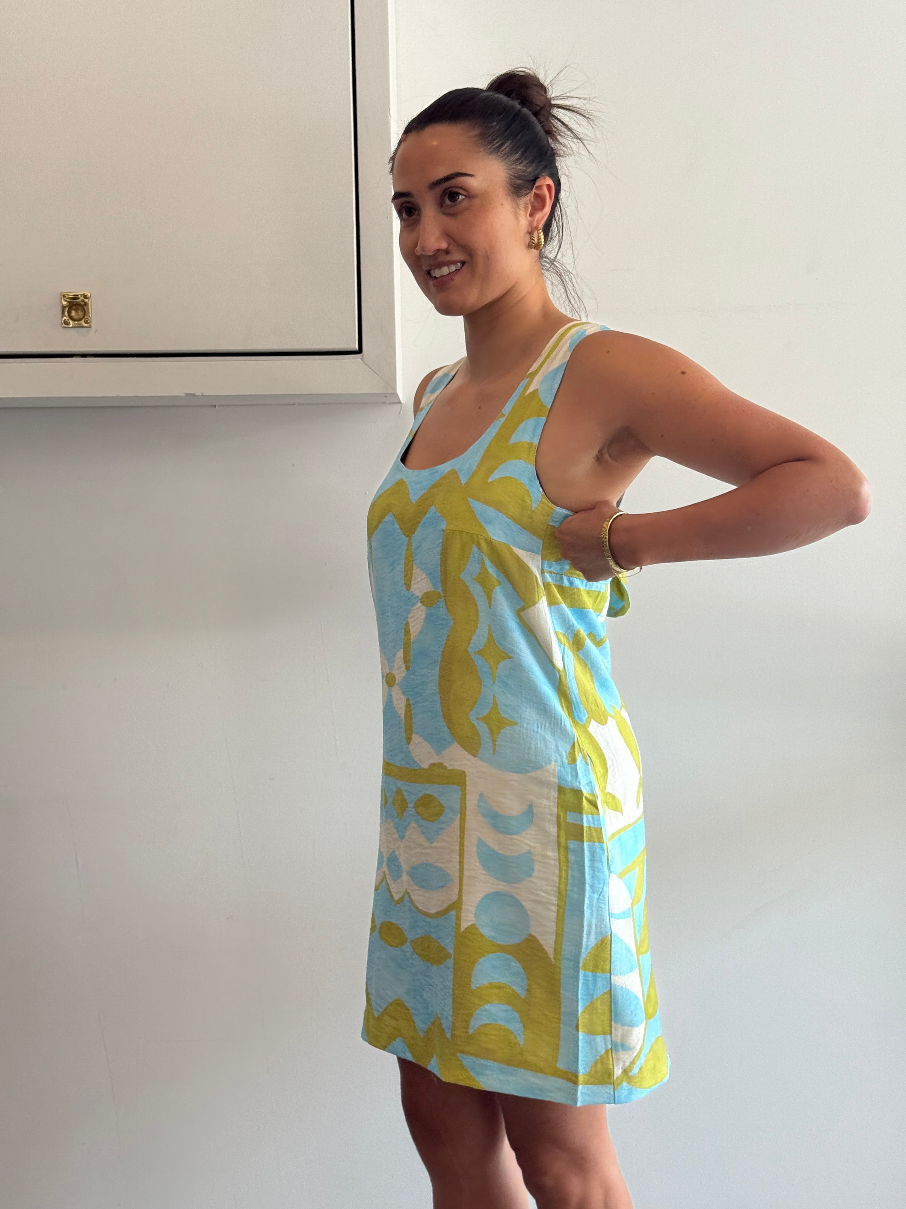 Woman holding a colorful towel with a geometric pattern against a white background