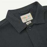 Dark gray jacket with a brand label on a light gray background