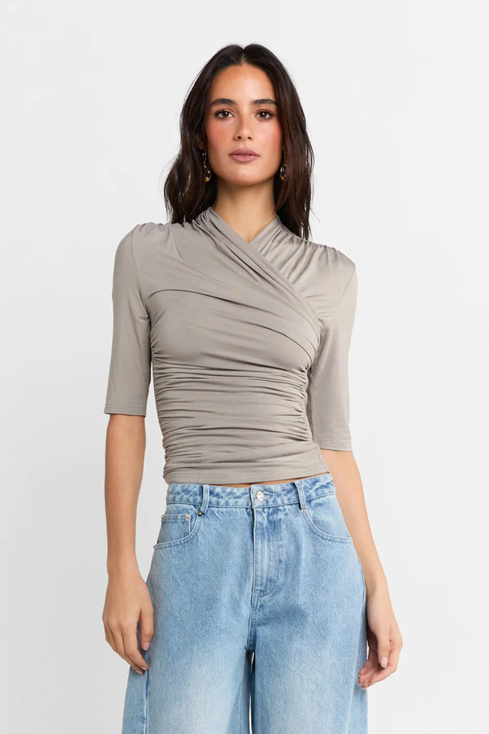 A woman shown wearing a Steel grey half-sleeve ribbed top and light-wash wide-leg denim jeans, against a plain white studio background.