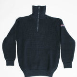 Blue half-zip sweater with a small logo on the sleeve against a white background
