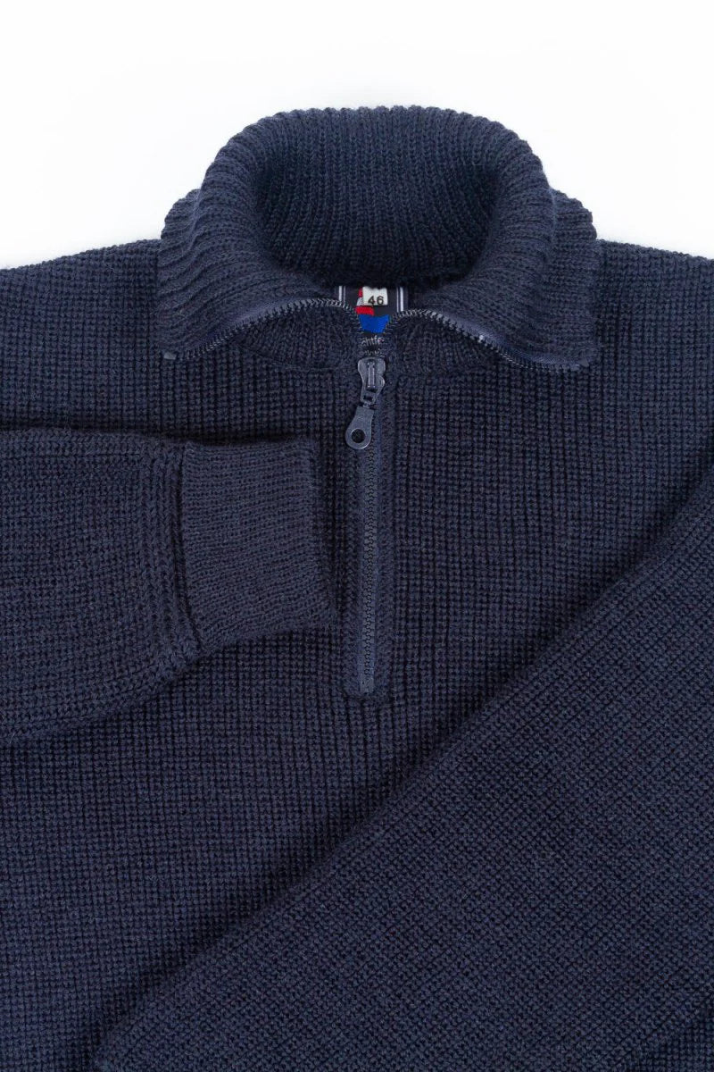 Dark Blue zip-up sweater with a brand label on a light gray background