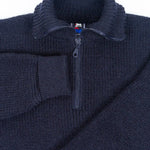 Dark Blue zip-up sweater with a brand label on a light gray background