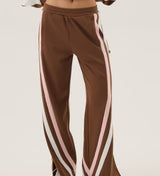Brown tracksuit with white and pink stripes on a light background
