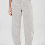 Person wearing light gray patterned pants on a white background