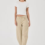 Woman wearing a white top and beige pants on a white background