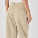 Beige pants worn by a person on a white background