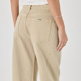 Beige pants worn by a person on a white background