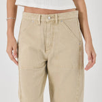 Beige pants worn by a person on a white background