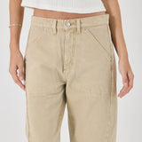 Beige pants worn by a person on a white background