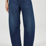 Person wearing blue jeans on a white background