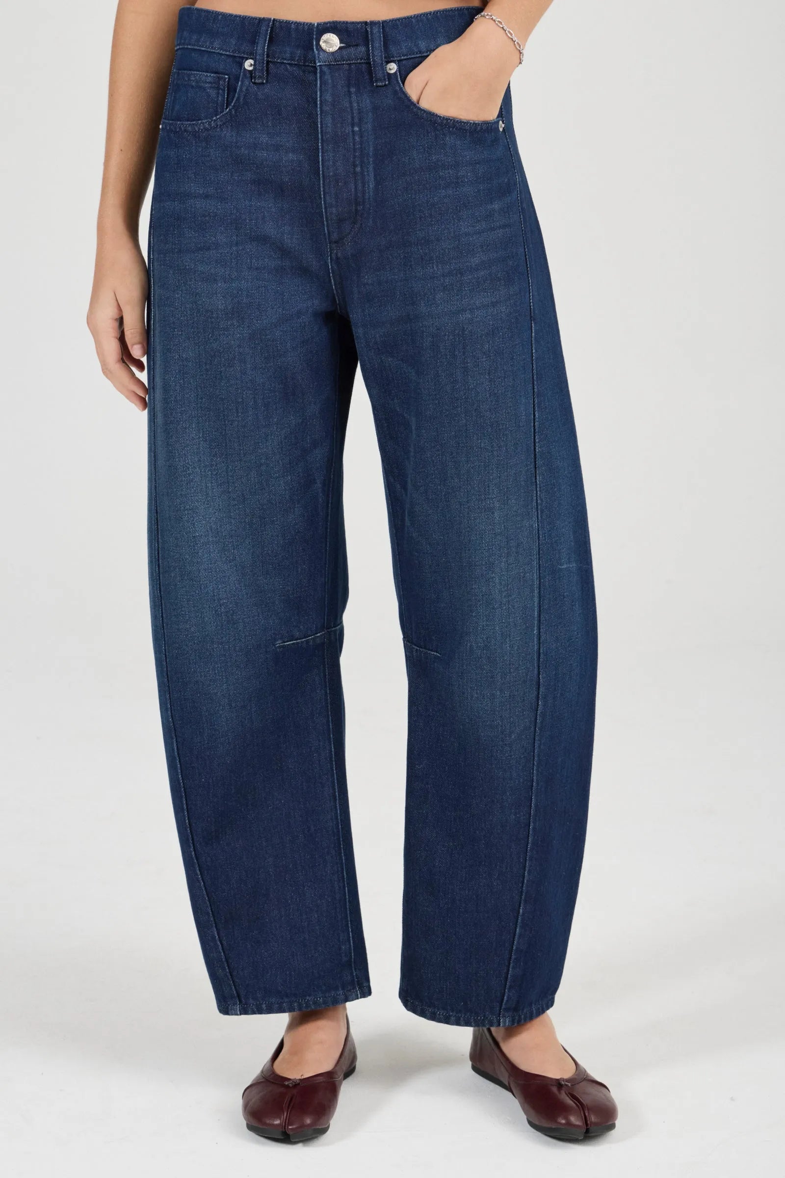 Person wearing blue jeans on a white background