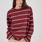 Woman wearing a red and white striped sweater on a plain background