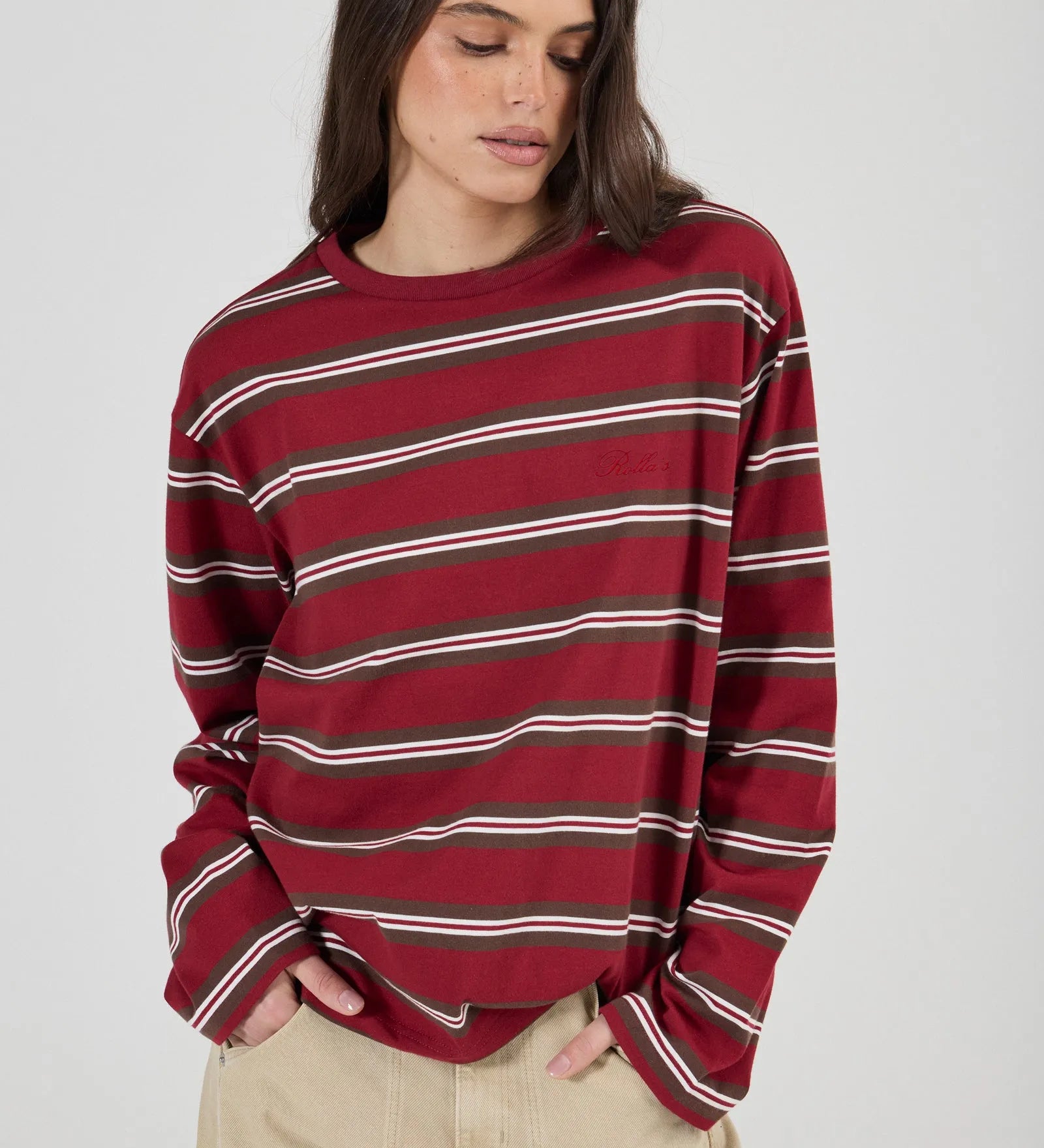 Woman wearing a red and white striped sweater on a plain background