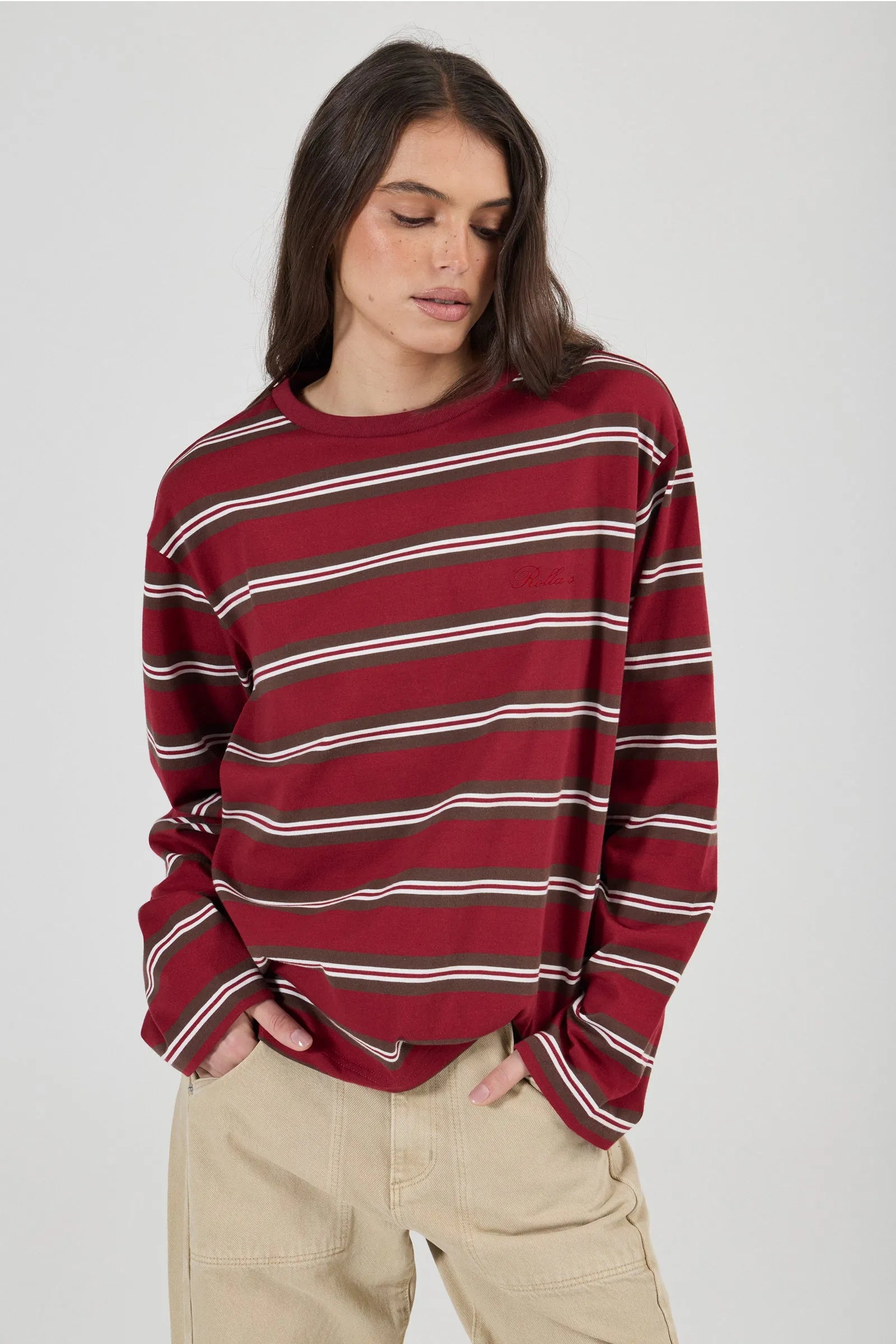 Woman wearing a red and white striped sweater on a plain background