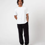 Person wearing a white t-shirt and Charcoal Cord pants on a white background