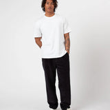 Person wearing a white t-shirt and Charcoal Cord pants on a white background