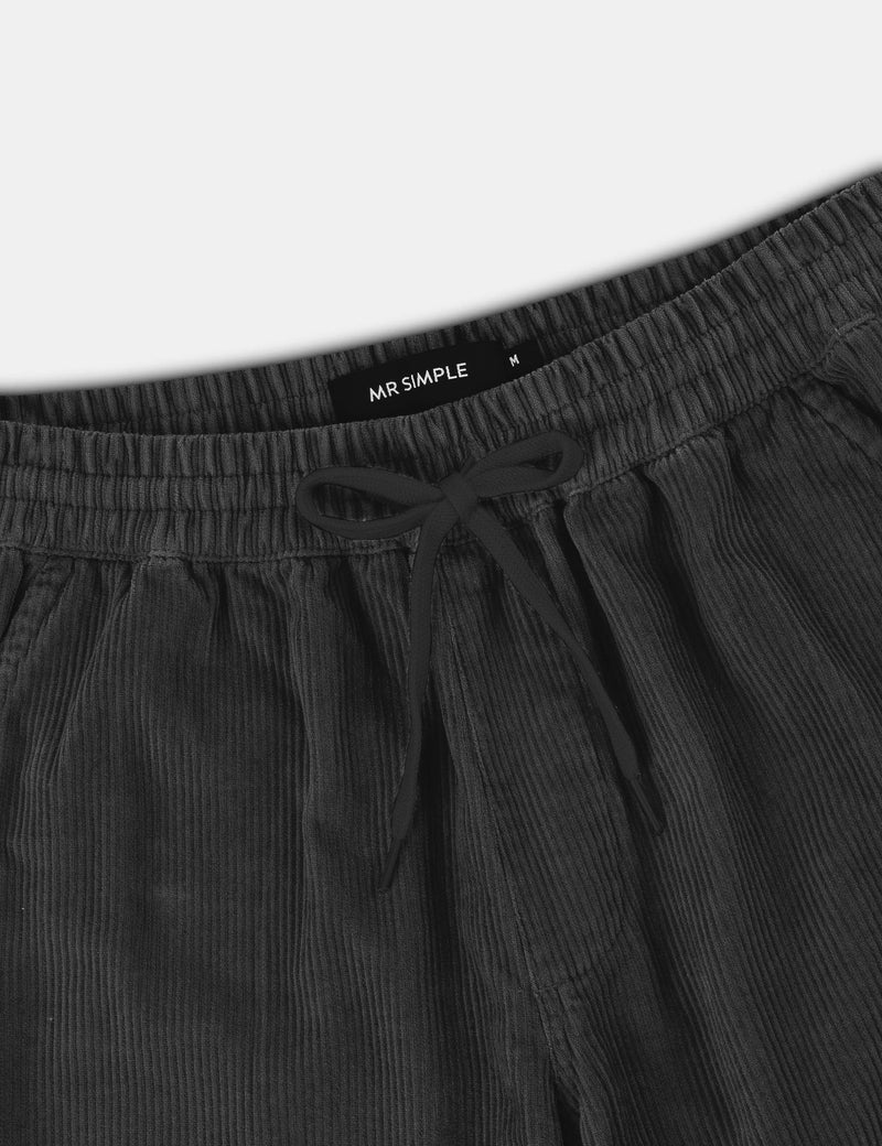 Dark gray pants with drawstring waistband on a white background, featuring 'MR SIMPLE' branding.