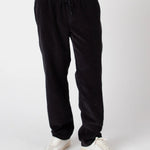 Black pants worn by a person on a white background