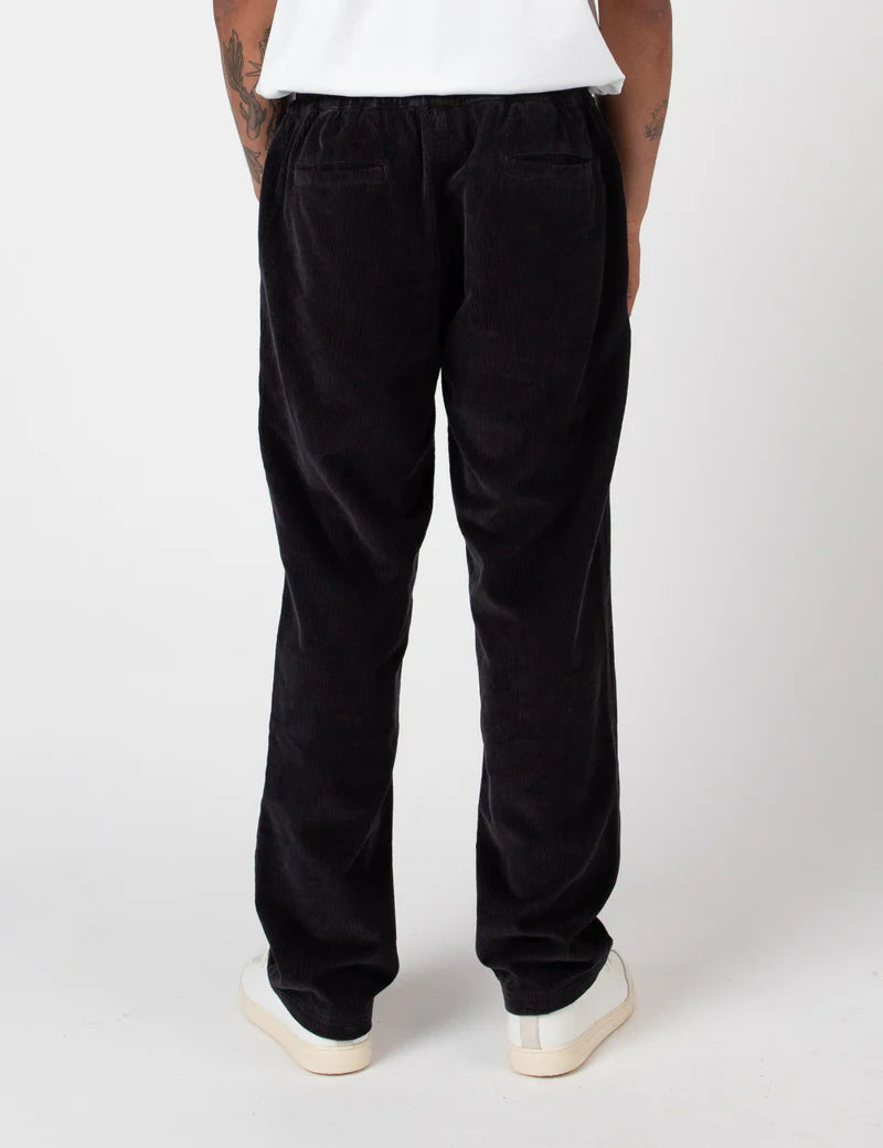 Person wearing black pants on a white background