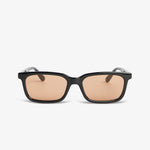 Black sunglasses with brown lenses on a white background