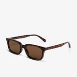 Sunglasses with a clear frame and dark lenses on a white background