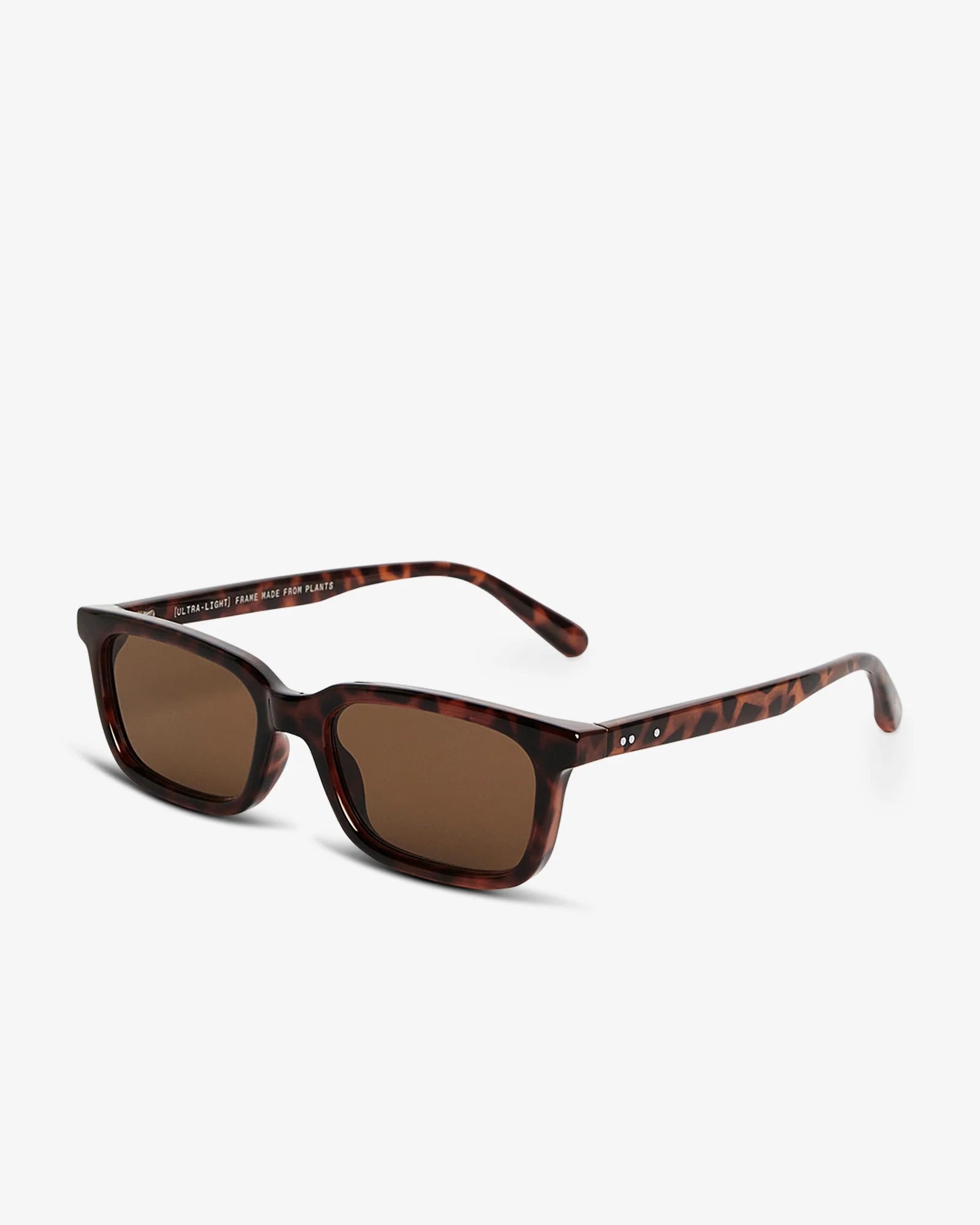 Sunglasses with a clear frame and dark lenses on a white background