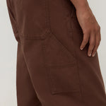Brown pants with multiple pockets on a plain background