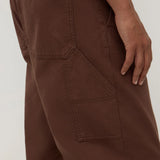 Brown pants with multiple pockets on a plain background