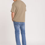 Man wearing Blue Jeans Beige top and denim cap on white Background