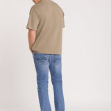 Man wearing Blue Jeans Beige top and denim cap on white Background