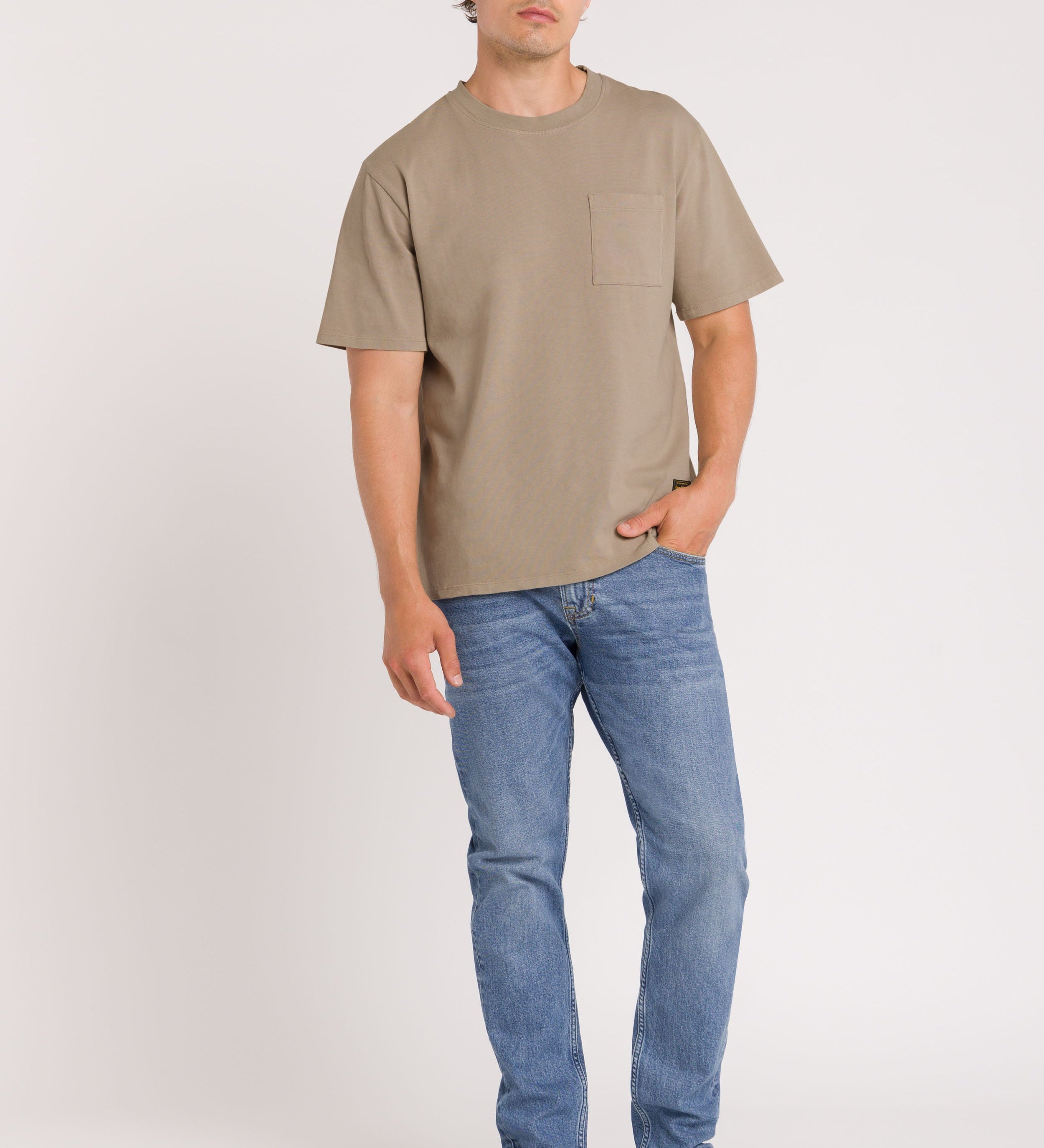 Man wearing Blue Jeans Beige top and denim cap on white Background