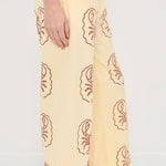 Yellow pants with Lobster pattern worn by a person on a white background