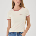 Woman wearing a cream t-shirt with maroon accents and blue jeans on a white background