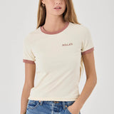 Woman wearing a cream t-shirt with maroon accents and blue jeans on a white background