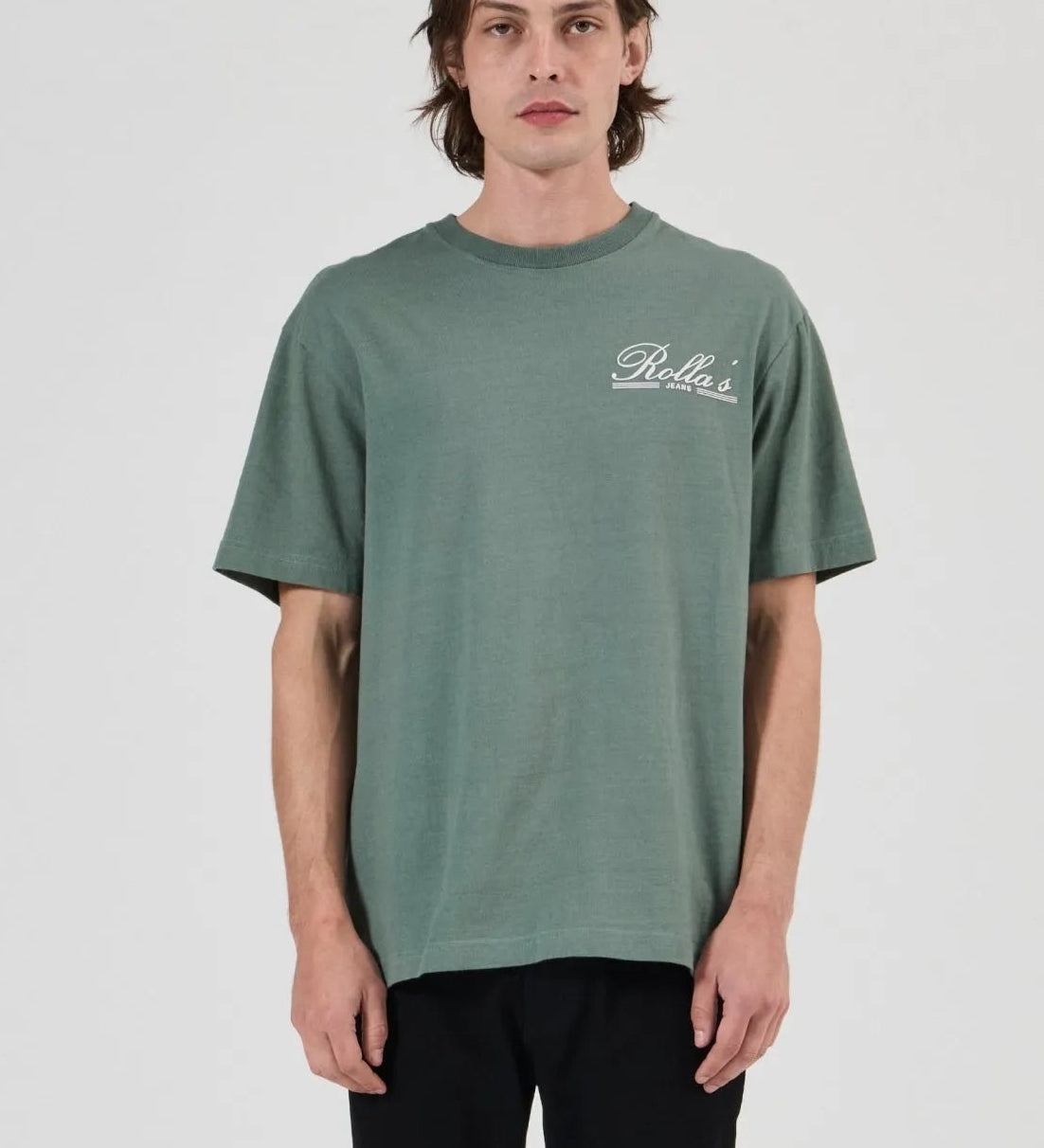 Person wearing a green t-shirt with a logo on a white background