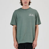 Person wearing a green t-shirt with a logo on a white background
