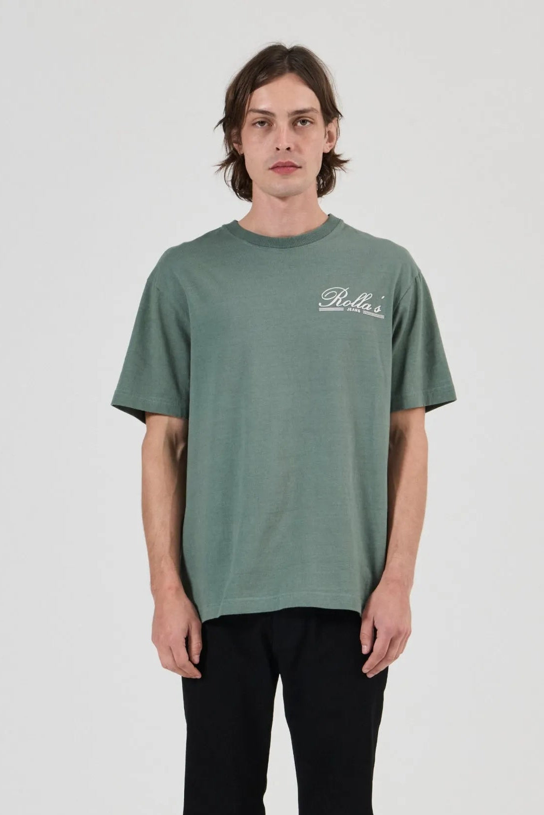 Person wearing a green t-shirt with a logo on a white background