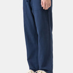 Person wearing navy blue pants with a white background