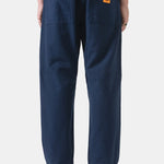 Person wearing navy blue pants with a white background