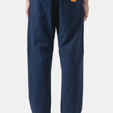 Person wearing navy blue pants with a white background