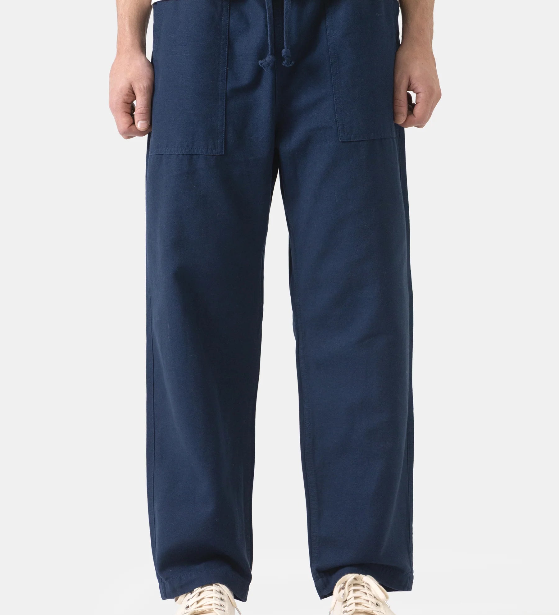 Person wearing navy blue pants on a white background