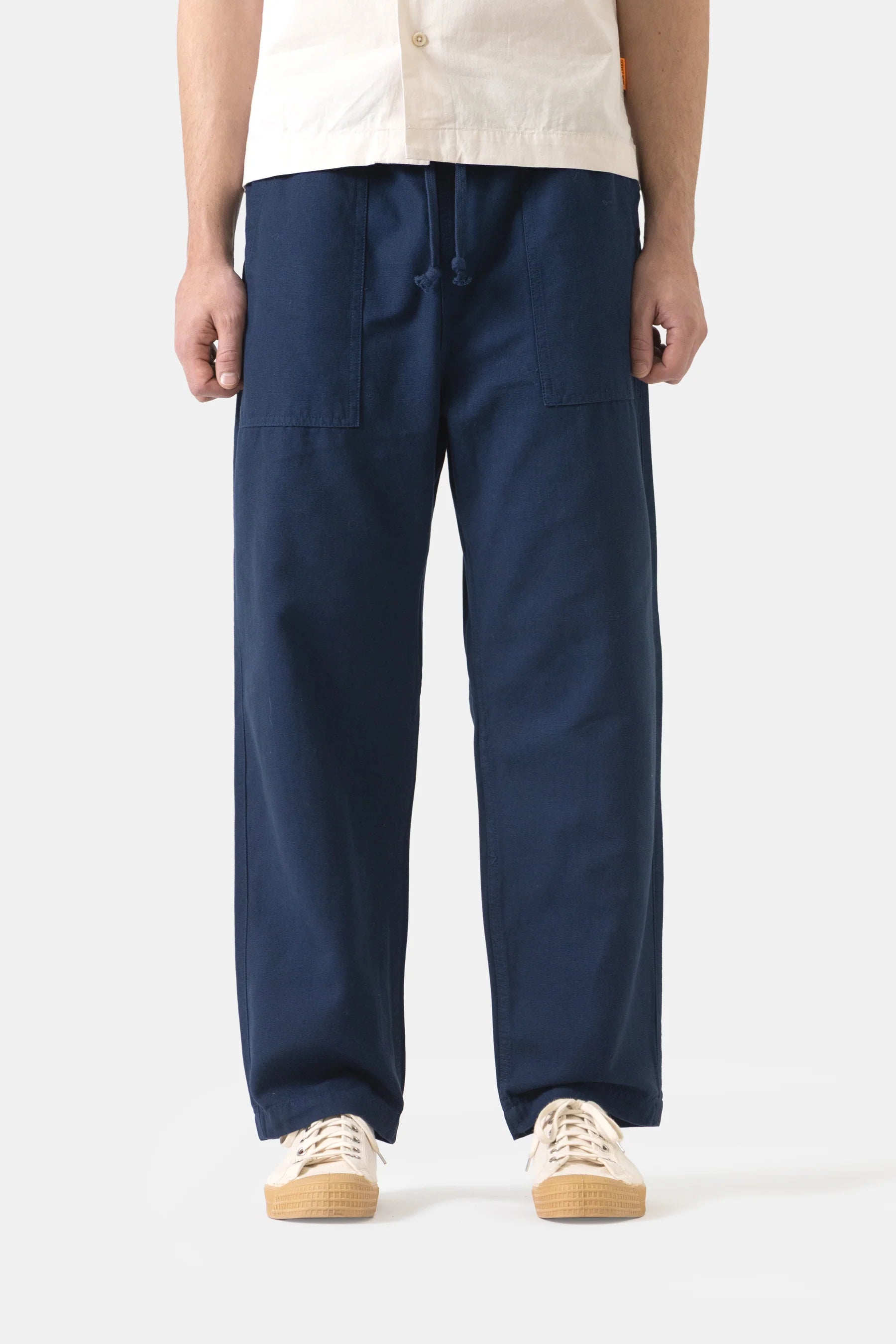 Person wearing navy blue pants on a white background