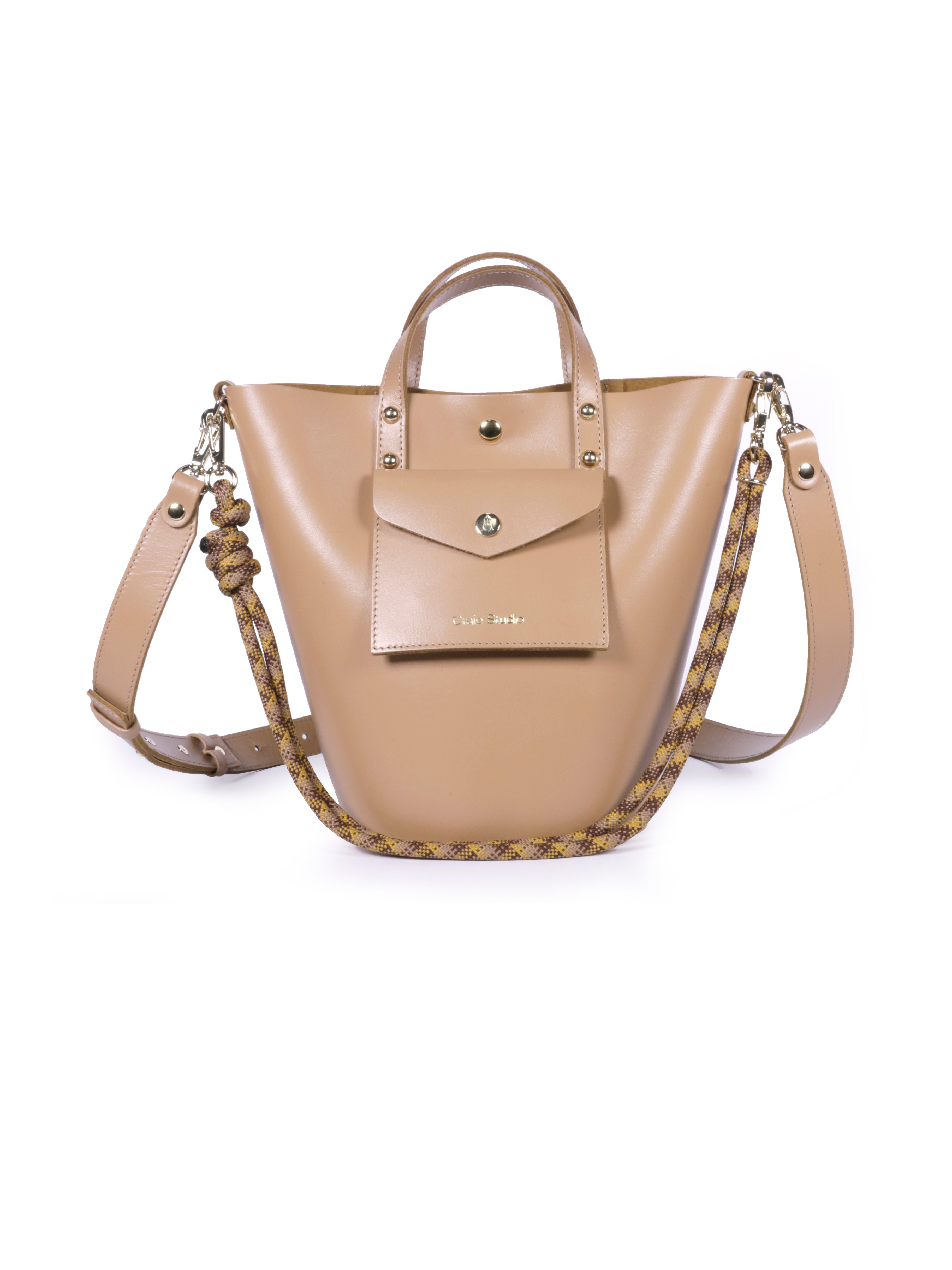 A mocha brown leather bucket bag with two shoulder straps and small leather handles. The bag is empty and displayed against a plain background.