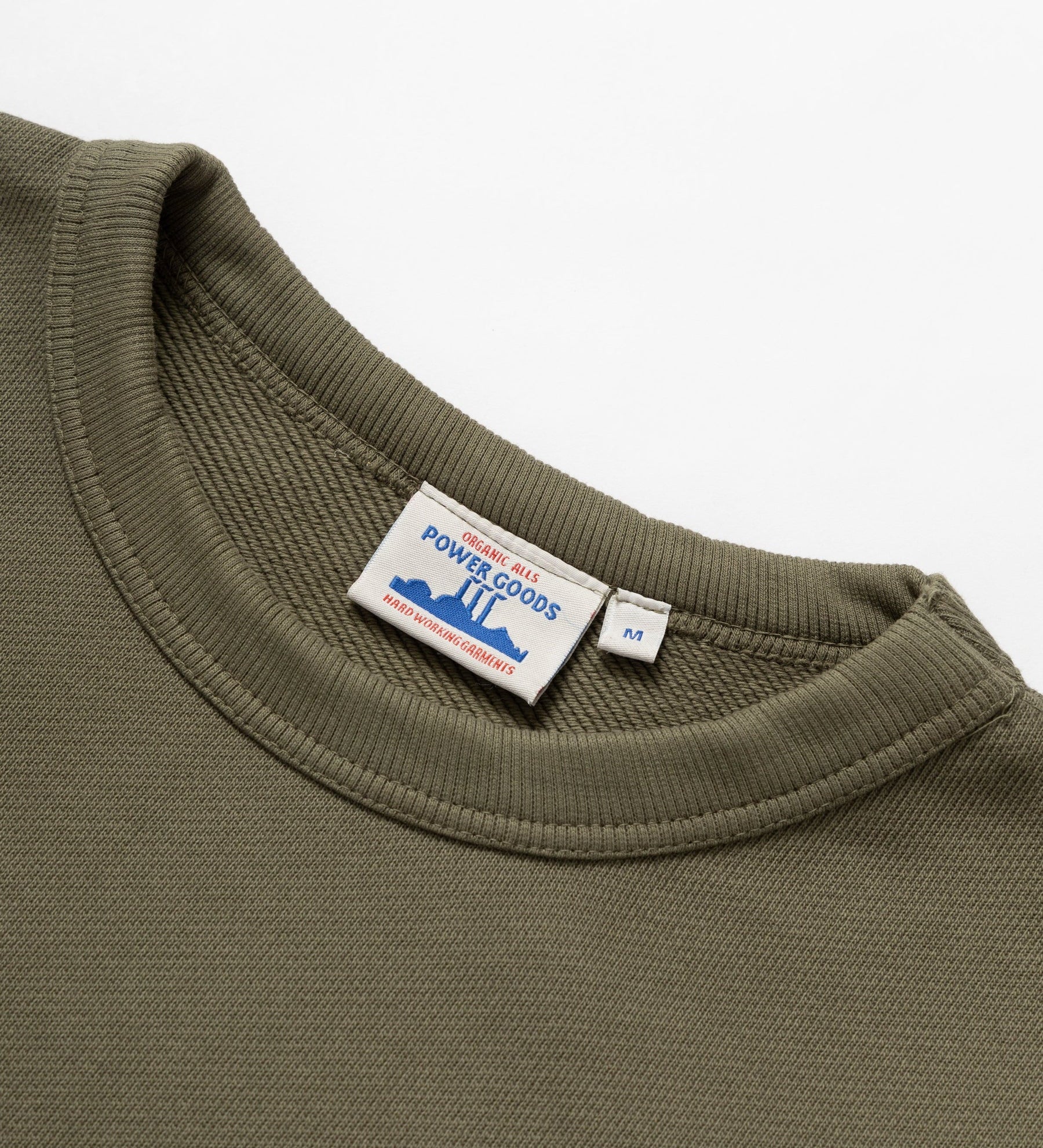 Green sweatshirt with a visible brand label on a white background