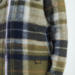Plaid shirt with a visible brand label on a white background