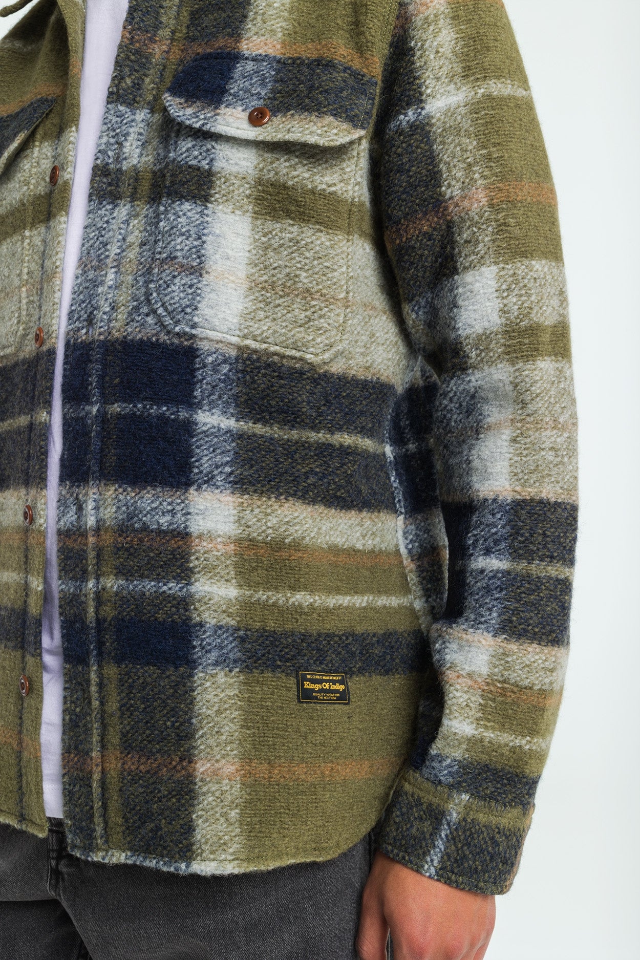 Plaid shirt with a visible brand label on a white background